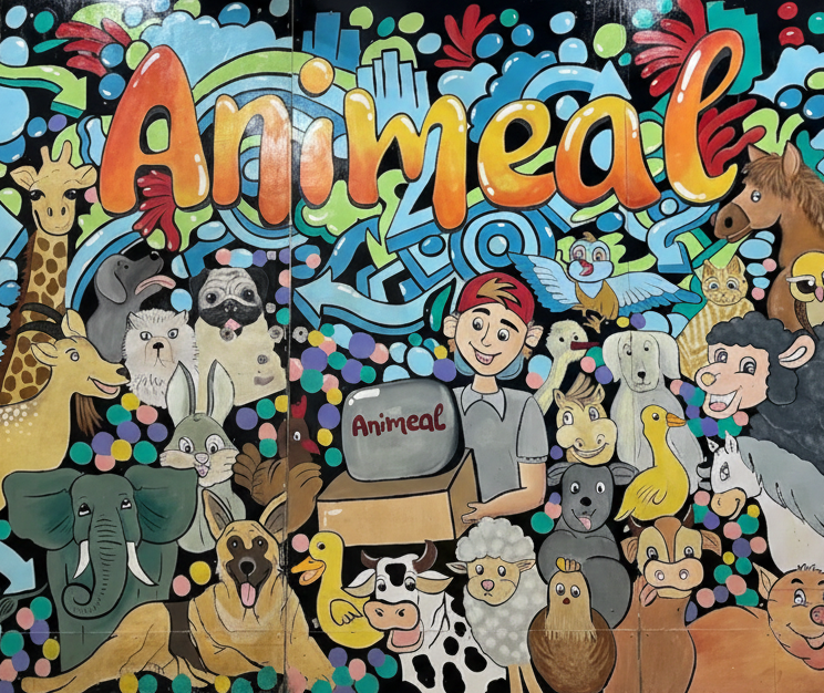 Colorful 'Animeal' branded mural with cartoon animals and characters on a wall.
