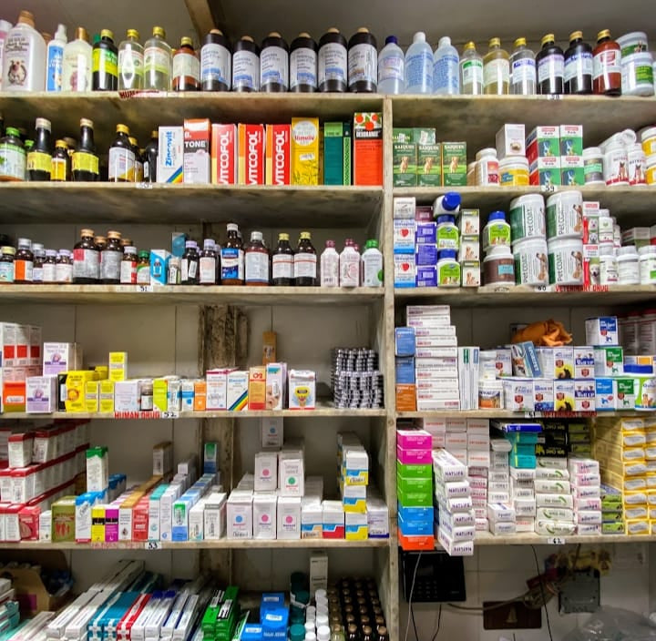 Shelves stocked with various bottles and containers in a pharmacy setting